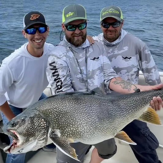 Fishing guides wearing WindRider hooded sun shirts on boat with trophy lake trout