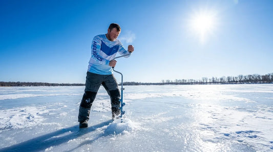 ice fisherman drilling hole on large frozen lake, bright sunny winter day, surrounded by snow and ice, clear blue sky, midday light, squinting slightly